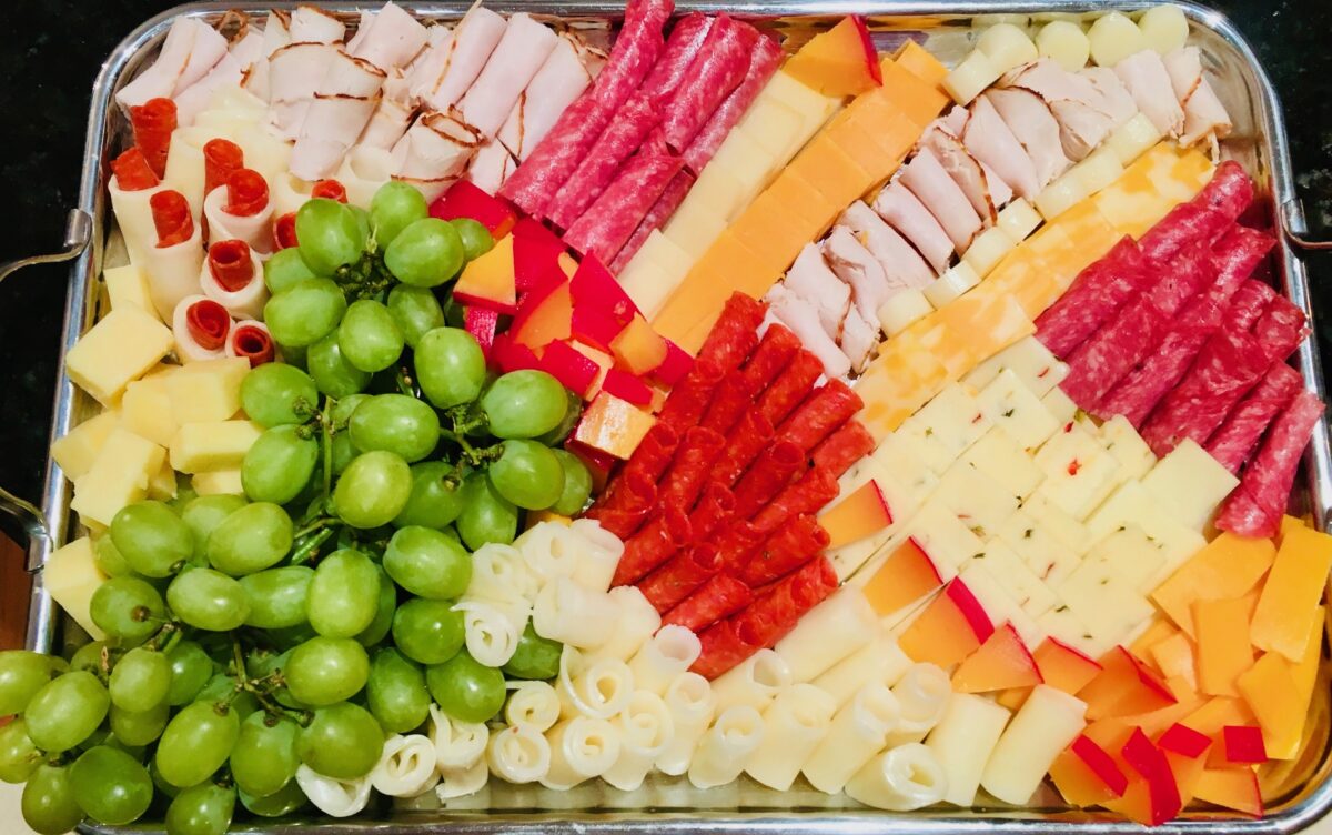 Charcuterie board with cheeses, meat and grapes