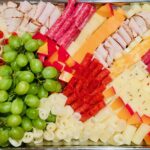 Charcuterie board with cheeses, meat and grapes